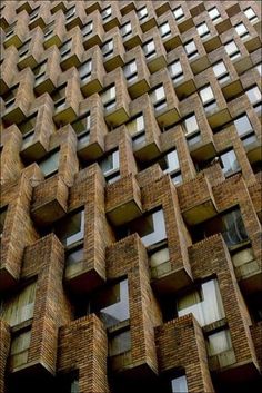 a very tall brick building with lots of windows