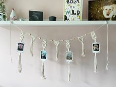 there are pictures hanging on the wall with tassels attached to it and some photos hung above them