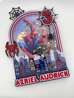 a spiderman sticker on the side of a refrigerator door that says azriel aurdck