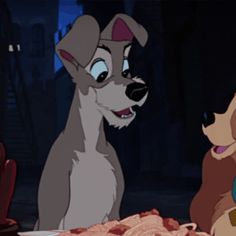 lady and the tramp sitting next to each other in front of a table full of food