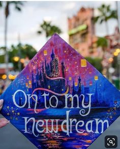 someone holding up a colorful graduation cap that says, or to my neuddream