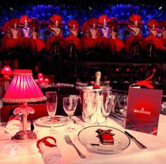 the table is set with silverware and red decorations