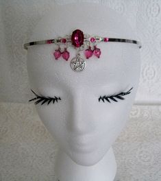 This beautiful circlet has a sterling silver plated filigree pendant with pink faceted glass setting, rhinestones, pewter silver pentacle, pink faceted beads, sterling silver plated bead caps and seed beads. Adjustable. Silver Mystical Jewelry For Party, Mystical Silver Jewelry For Party, Handmade Pink Fantasy Jewelry, Adjustable Fantasy Jewelry For Festivals, Adjustable Fantasy Festival Jewelry, Silver Fantasy Jewelry For Festivals, Adjustable Silver Wire Wrapped Body Jewelry, Silver Fantasy Crown-shaped Jewelry, Adjustable Silver Spiritual Body Jewelry