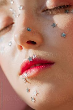 a woman's face with stars on her cheek and nose by jovo studio for stockstation