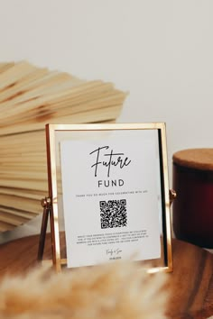 there is a sign that says future fund next to a wooden box with a q - code on it