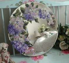 there is a mirror with flowers on it