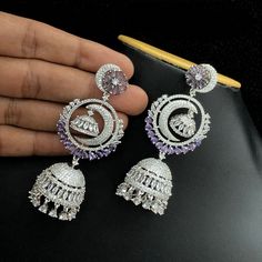 These Silver Polish American Diamond Long Chandbali Jhumka Earrings are perfect for a special occasion. With an intricately detailed crescent moon dangle and radiant American diamond, they shine as exquisitely as they look. Ideal for traditional Indian weddings, these earrings will make an iconic statement. Length of the Earrings 3.25 Inches Indian Wedding Earrings, Moon Earrings Dangle, Silver Earrings Wedding, Crescent Moon Earrings, Silver Polish, Traditional Indian Wedding, Indian Weddings, Jhumka Earrings, Cz Jewelry