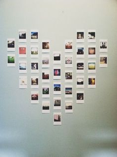 a white refrigerator freezer sitting next to a wall with pictures on the back of it