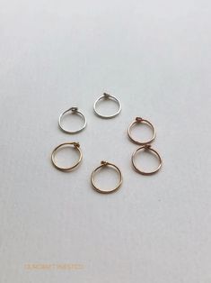 TINY Hoop Earrings ROSE GOLD Sleepers Huggie Hoops Endless | Etsy Tiny Gold Hoop Earrings, Different Ear Piercings, Tiny Hoop Earrings, Earrings Rose Gold, Tiny Earrings, Earrings Minimalist, Rose Earrings, Gold Hoops, Rose Gold Earrings