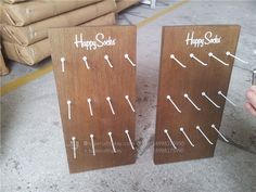 two wooden signs with arrows and happy socks written on them