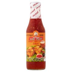 a bottle of hot sauce with chicken wings on the top and red peppers in the bottom