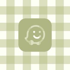 a green square with a smiling face on it's side and a checkered background