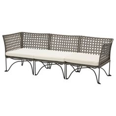 an outdoor wicker couch with cushions on it's back and side panels, in grey