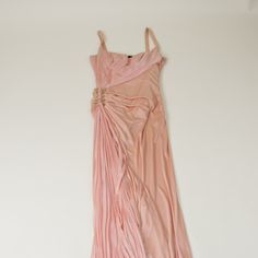 From The Archives. Nobody Does Evening Wear Quite Like Vintage Roberto Cavalli. Sexy And Sultry, This Peach-Colored Evening Gown Features A Pleated Bust And Side Train, With A Silk Overlay Of A Darker Peach That Drapes Across The Waist And Is Cinched By Gold Clasps At The Waist. The Perfection Of Italian Tailoring Is Evident. This Dress Fits And Flows Like A Dream. Bust: 24.75" Waist: 19.75" Hip: 26" Length: 52.25" Size Tag Removed. Material Tag Removed. Pink Pre-draped Silk Evening Dress, Italian Tailoring, Roberto Cavalli Dress Vintage, Silk Overlay, Roberto Cavalli Pink Dress, Roberto Dress, Roberto Cavalli Green Dress, Vintage Roberto Cavalli, Vintage Evening Gowns