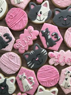 many decorated cookies with cats and hearts on them