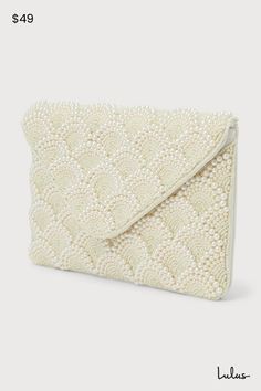 Special occasions deserve luxe accessories like the Lulus Glowing Aura Ivory Pearl Beaded Clutch! This stunning clutch boasts a scalloped design across the front, with beaded semi-circles accented by luminous faux pearls. An envelope-style flap has a magnetic closure that opens to reveal a spacious interior with a single sidewall pocket. Carry it as a chic clutch, or use the attachable silver chain to convert it to a convenient crossbody! Lined. Clutch measures 10. 5" wide, 7" tall, and 0. 5" de Chic Beige Embellished Clutch, Beaded Beige Clutch For Events, Cream Clutch With Pearl Embroidery For Events, Cream Beaded Clutch For Party, Elegant Beaded Cream Clutch, Beige Beaded Clutch For Events, Elegant Beaded Beige Clutch, Cream Beaded Party Clutch, Chic Beaded Beige Clutch