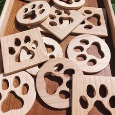 wooden cutouts with holes in them are on a table top, ready to be made into ornaments