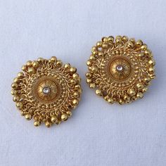 22k Gold Big India Stud Earring features Ghungroo and Kundan, reminiscent of Amrapali's iconic designs. These Jadau statement earrings exude designer elegance, ideal for premium weddings. Inspired by antique Bollywood jewelry, they are a glamorous addition to any bridal ensemble, promising timeless allure and cultural richness. *𝐏𝐑𝐎𝐃𝐔𝐂𝐓 𝐃𝐄𝐓𝐀𝐈𝐋* * Material: Brass * Plating:   Gold Plated *DIMENSIONS * * Earrings:    Weight: 22 gm each, Length: 1.7Inches, Width: 1.7 Inches *𝐃𝐈𝐒𝐂𝐋 Ghungroo Earrings, Amrapali Jewellery, Kundan Studs, 22k Gold Earrings, Polki Earrings, Traditional Earrings, Bollywood Jewelry, Golden Earrings, Kundan Earrings