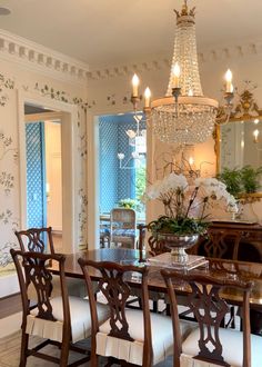 a dining room table and chairs with chandelier