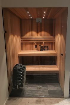 an empty wooden sauna with shelves and bins