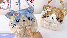 two crocheted purses with cats on them, one has a flower in it