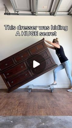 a woman is pushing a dresser with her feet on the floor and text reads, this dresser was hiding a huge secret