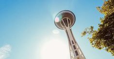 the space needle in seattle, usa is seen from below as the sun shines brightly