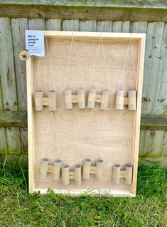 a wooden board with cups hanging from it