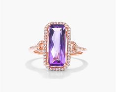 This gorgeous cocktail ring is crafted in 14K rose gold and features a 15.0x6.0mm emerald-cut amethyst center stone. The amethyst is surrounded by a halo of diamonds and the ring band is pav Set Ring, Diamond Settings, Engagement Ring Styles, Fancy Color Diamonds, Dream Ring, February Birth Stone, Designer Engagement Rings, Diamond Halo, Ring Band