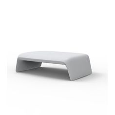 a white foot stool sitting on top of a white floor