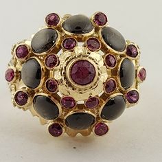 14 karat yellow gold Black Star Sapphires And Ruby Vintage dome Ring weighing 7.3 grams, size 6. This ring is 17 millimeter in diameter and 13 millimeter high. Gold Domed Ruby Ring With Gemstone, Gold Ruby Ring With Domed Shape, Yellow Gold Enamel Cabochon Ring, Yellow Gold Round Cabochon Enamel Ring, Yellow Gold Cabochon Enamel Ring, Yellow Gold Enamel Ring With Cabochon, Yellow Gold Domed Gemstone Ring, Gold Domed Collectible Ring, Gold Enamel Multi-stone Round Ring