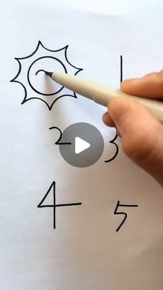 someone is drawing numbers on paper with a pencil