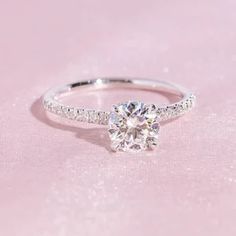 a diamond ring on a pink background