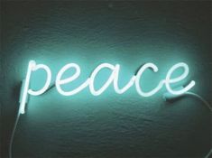 a neon sign that says peace on it