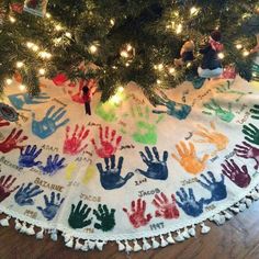 a christmas tree skirt with handprints on it