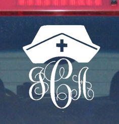 the monogrammed car window decal has an image of a boat and cross on it