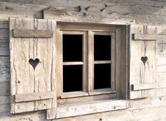 an old wooden window with hearts on it