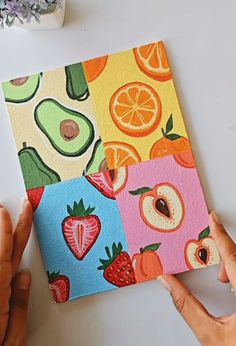 someone is painting fruit and vegetables on paper