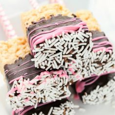 three pieces of cake with sprinkles and chocolate on top are stacked together