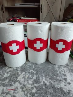 three rolls of toilet paper with the flag of switzerland on them