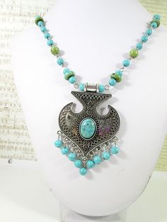 "Lovely Turquoise Necklace.  It features a blue and green turquoise bead and chain necklace with an antique silver tone metal pendant adorned with a turquoise cabochon and with turquoise bead tassels.  It is a great gift to give or to keep, perfect gift for wife, for mother, sister or best friend, suitable gift for birthday, anniversary.  Measurement: pendant with tassel approx.: 3\" x 2\" total bead and chain necklace approx.: 20\" - 28\" with lobster clasp closure. (bead chain approx. 12\" in Vintage Green Beaded Turquoise Necklace, Nickel-free Bohemian Turquoise Metal Necklace, Bohemian Nickel-free Turquoise Metal Necklace, Bohemian Nickel-free Turquoise Necklace, Turquoise Beaded Metal Necklace, Turquoise Beaded Chain Necklace In Metal, Handmade Turquoise Metal Necklace, Turquoise Jewelry With Silver Beads, Bohemian Turquoise Beaded Chain Necklace