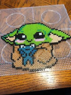 an image of the baby yoda from star wars made out of perler beads