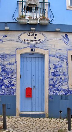 a blue and white building with a red door