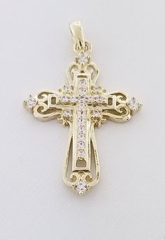 "Beautiful solid yellow gold cross. This piece features a fancy cross with Cubic Zirconia stones. Details: Style: Cross Weight: 2.3 grams Primary Stone: Cubic Zirconia Stone Shape: Round Length: Appx. 1 1/4\" including bail Width: Appx. 1/2\" Metal: 14k Yellow Gold Condition: Brand new! The bail of the pendant is stamped with '14k'. PACKAGING: Each item comes in a jewelry box and wrapped beautifully as a gift. If you would like us to include a gift note in the parcel, please leave us a message w Yellow Gold Cubic Zirconia Cross Necklace, Cubic Zirconia Crucifix Cross Necklace With Diamond Accents, Crucifix Cross Necklace With Diamond Accents In Cubic Zirconia, Cubic Zirconia Cross Necklace With Diamond Accents, Diamond Accented Cross Necklace, Gold Cubic Zirconia Cross Necklace, Gold Cross Necklace With Diamond Accents For Anniversary, Gold Crucifix Cross Necklace With Diamond Accents, Fancy Cross