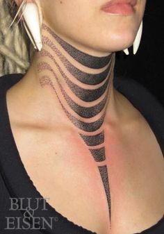 a woman with black and white tattoos on her neck