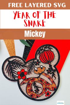 the year of the snake mickey mouse is featured in this free layered svg file