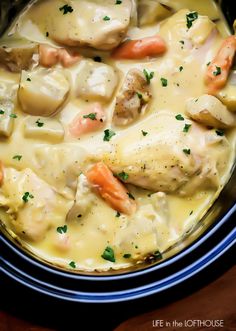 crock pot creamy ranch chicken with carrots and potatoes in a white broth