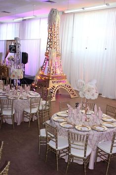 the eiffel tower is lit up in pink and white for a wedding reception