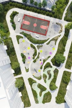 an aerial view of a basketball court in the middle of a park with lots of trees