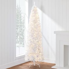 a white christmas tree with lights in a room